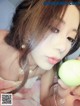 A woman holding a green ball in her hand.